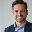 Portrait of a smiling man, a client of Healthy Nutrition Makassar, looking healthy and happy.