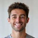 Portrait of a smiling young man, a client of Healthy Nutrition Makassar, looking healthy and energetic.