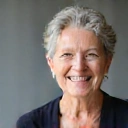 Portrait of a smiling middle-aged woman, a client of Healthy Nutrition Makassar, looking vibrant and healthy.